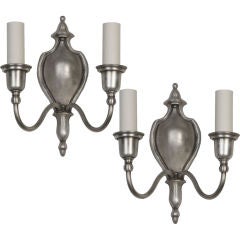 A pair of double-light sconces by the maker Bradley & Hubbard