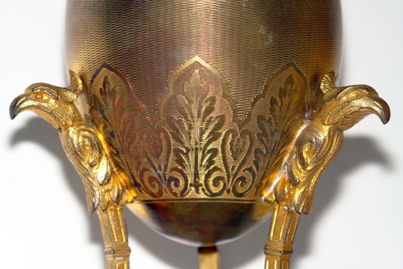 A circa 1920's Swedish gilt metal egg on tripod base. 

Measurements:
Height: 10