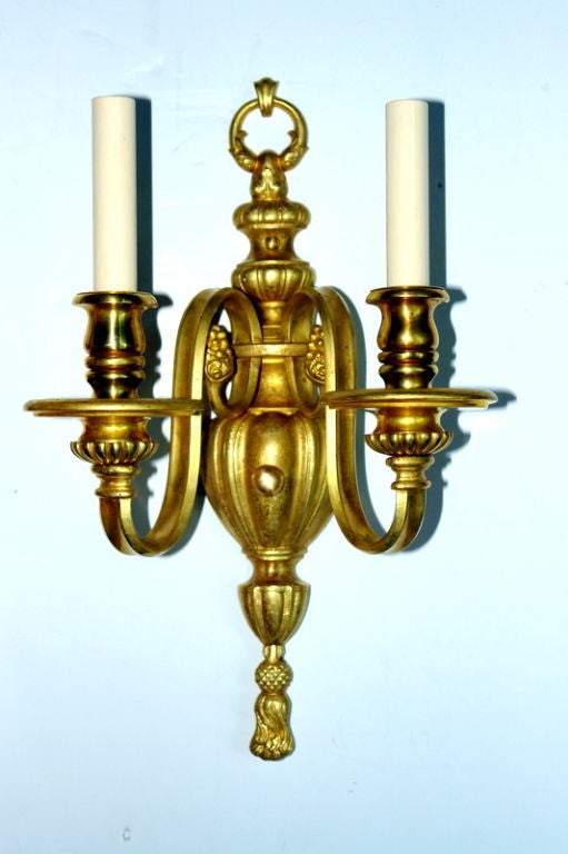 A pair of circa 1920's gilt bronze Neoclassic  sconces with original patina.

Measurements:
Height: 16.5 ”
Depth: 7 ”
Width: 10?.