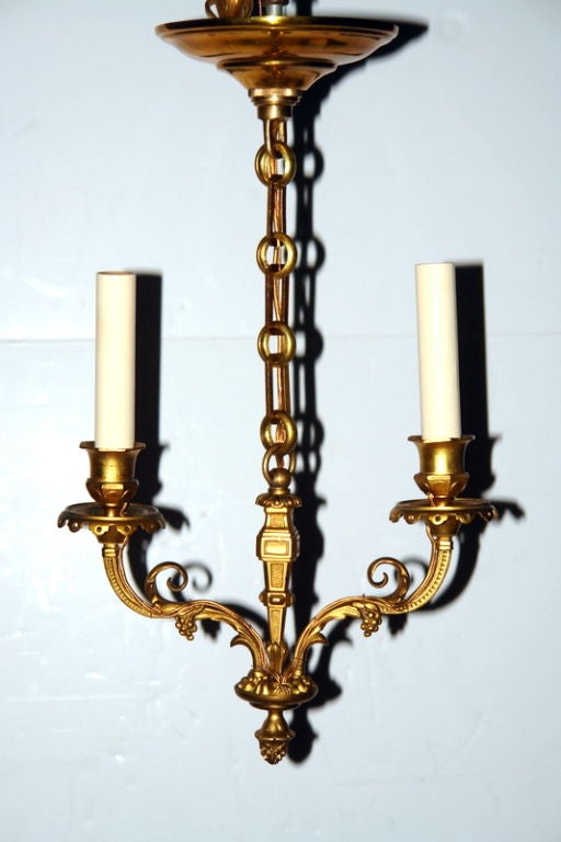 An unusual pair of neoclassic style double light chandeliers. Foliage motif on arms and body. Original bronze doré finish.
Measurements:
Hight: 17