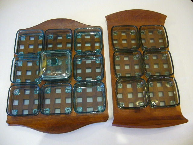 ....SOLD DECEMBER 2010..Two variations of Jens Quistgaard's iconic teak tray design for Dansk.  Waffle design holds movable shallow Swedish glass bowl inserts for serving condiments, sauces, nuts, etc.   Both with slatted teak centers with shaped