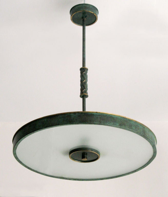 Elegant Swedish Art Deco ceiling fixture in green painted and patina brass with polished details. Original canopy and frosted glass. There are three standard sockets. Height 26
