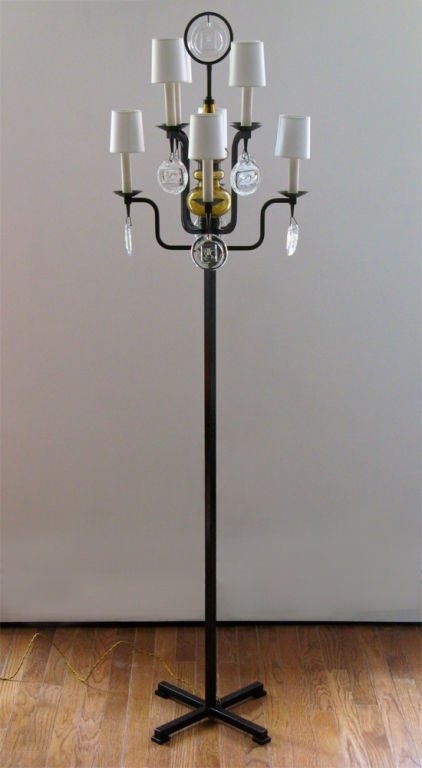 Stylish 8 arm candelabra floor lamp by Swedish designer Erik Hoglund for Boda Nova. Each arm has a thick crystal with an impressed image of a fish or a face, 9 in total. The center stem has two hand forged amber glass pieces. Newly electrified with