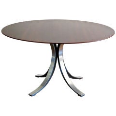 Osvaldo Borsani round dining table with steel base wood top.