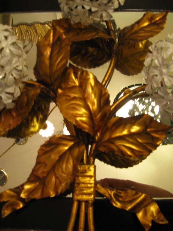 Beautiful and graceful hydrangea sconces with gold gilt. amazing when lite by 3 lights that are placed behind each hydrangea head.