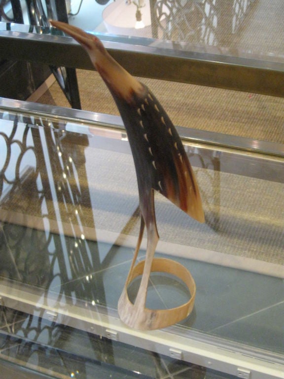 Hand carved horn depicts interesting bird.