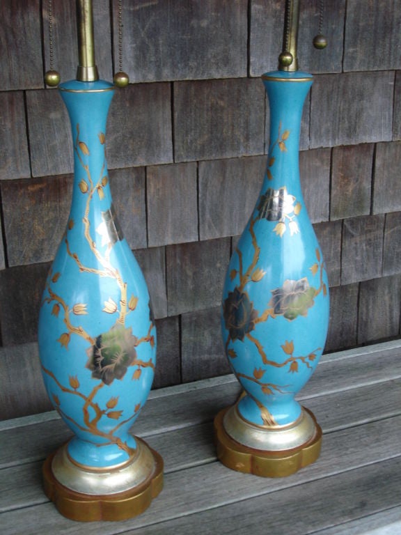 Asian design with chrysanthemums in gold and silver tones over a wonderful turquoise glazed ceramic base. These sit on a two-tones gilded wood base. Just Exquisite. Partial Marbro label on one of the lamps.