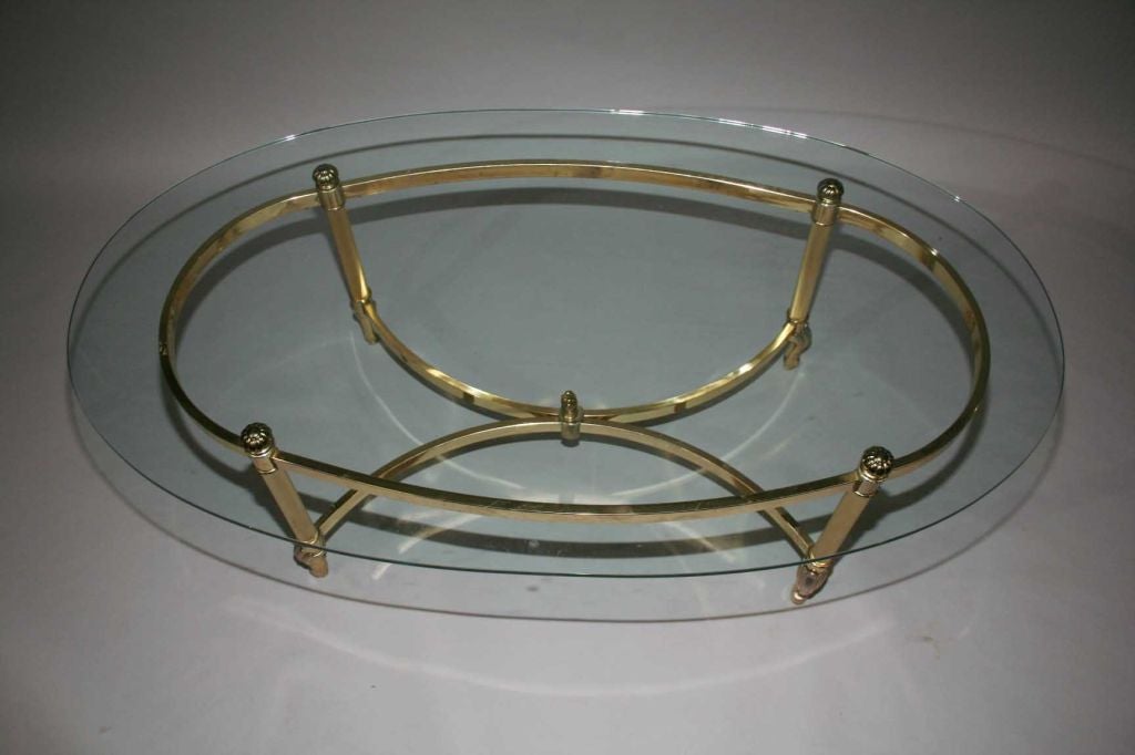 Oval Glass top with brass and chrome metal base.