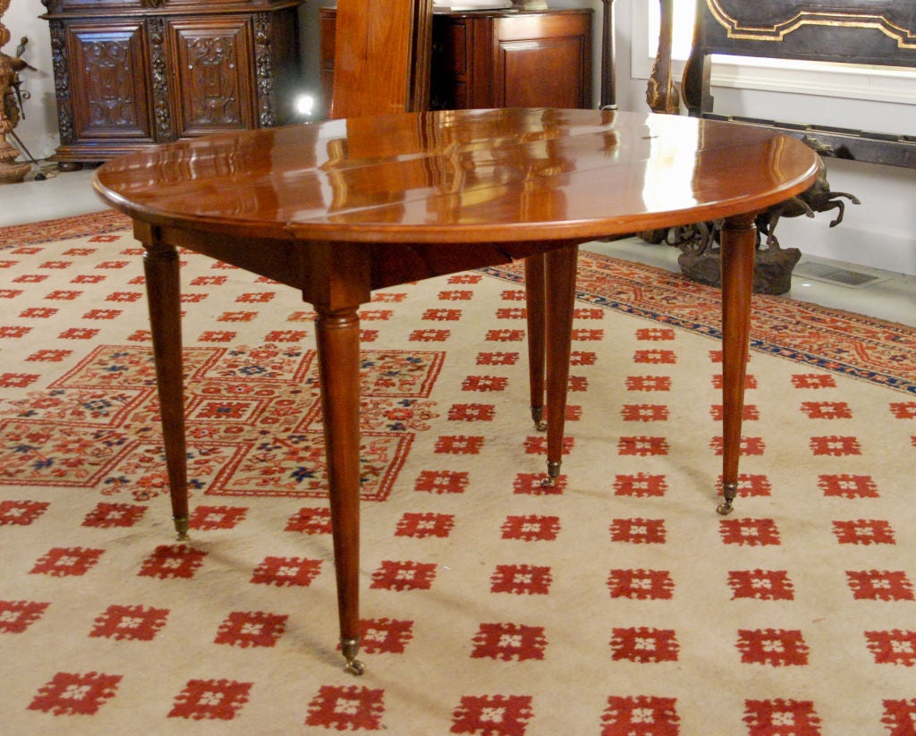 A Louis XVI Faded Mahogany Round Extending Dining Table