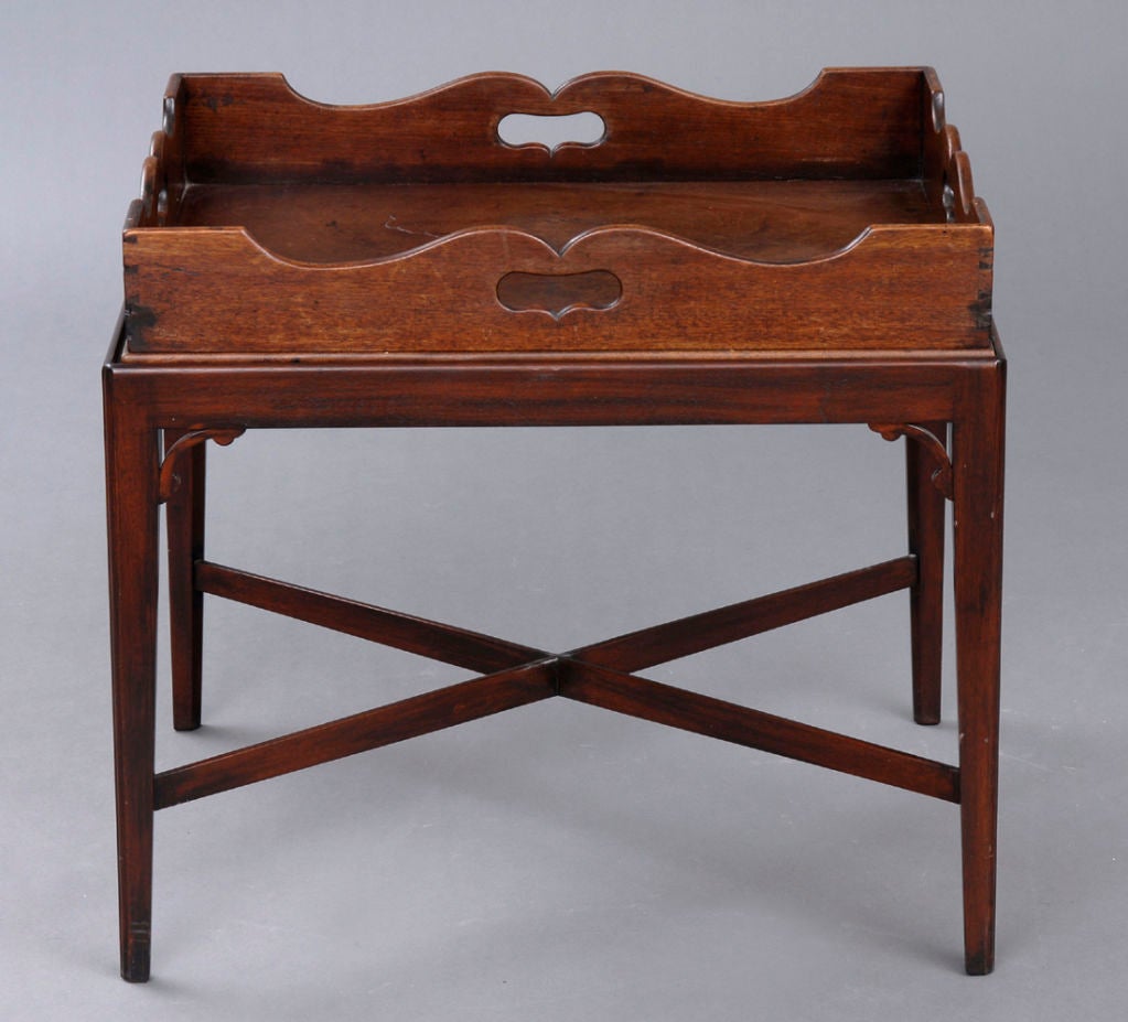 Georgian Cuban mahogany tray with scalloped shaped gallery and pierced carrying handles. Later custom-made stand with X-shaped stretcher and tapering chamfered legs.
