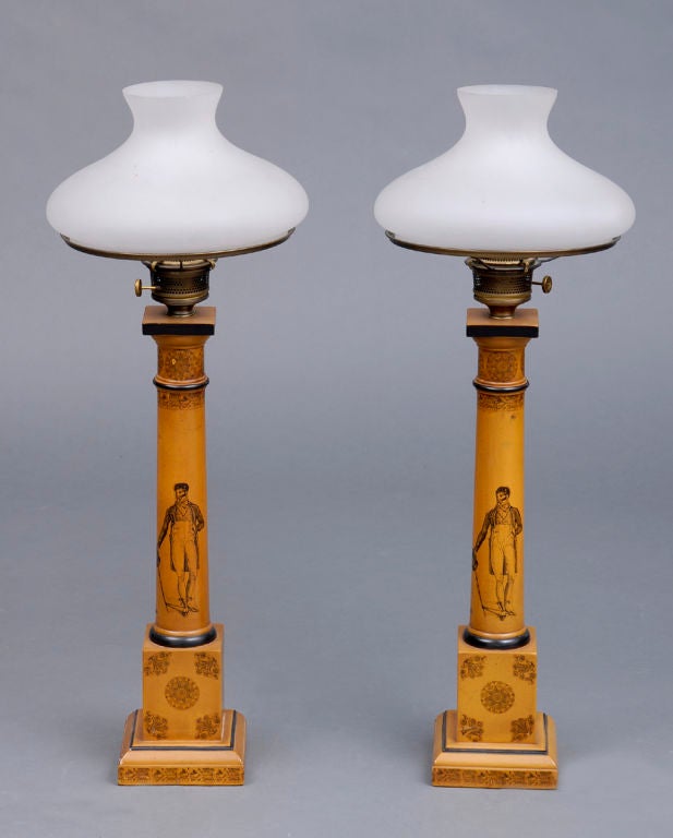 Pair of tall gold painted wooded lamps converted from gas with Regency style black transfer decoration and milk glass shades.