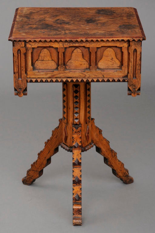 Hand-carved English pine Folk Art single drawer tripod table with chip carved top edge, bottom of frieze and pedestal, Gothic trefoil designs around frieze and retaining some of it's original red paint. The table is freestanding.