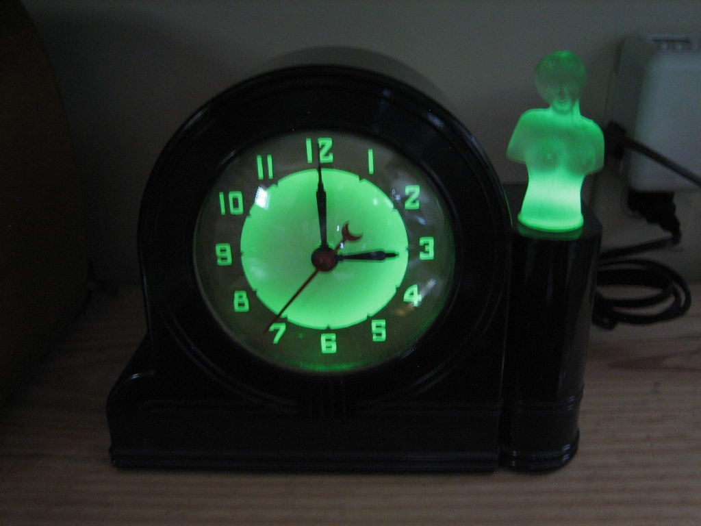 This is a 1930’s Lackner Neon Glo clock made in Cincinnati, Ohio. The case is made of black Bakelite and the nude figure is made of frosted glass. It is all original and in working condition. It does have one minor little flake on the right rear