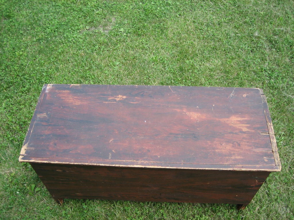 An early hand hewn, grain painted Pennsylvania 6 board blanket chest with Original till and leather hinges. The beautiful grain paint is over an early red wash. The bottom, back and inside are natural. It is in great condition for its age, over 200