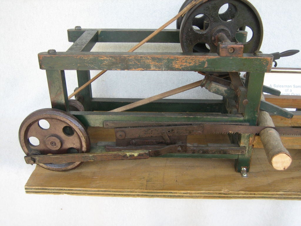 This is a great old, salesman sample of a commercial drag saw. It works! It looks to be 19th Century. It was mounted on a modern piece of plywood for easy transport and stability. It looks very early and primitive. The part that supports the logs
