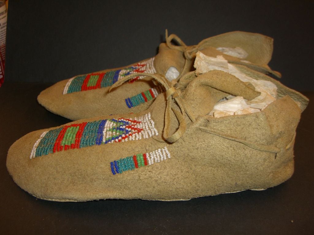 A very nice pair of Native American Indian beaded Moccasins made from deerskin. They have held their form nicely as they have been kept to form with tissue.