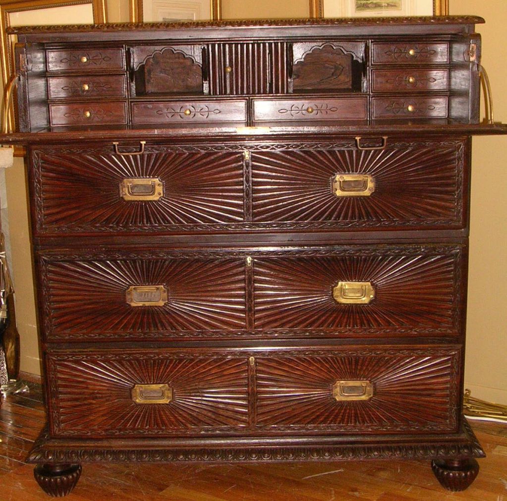 A 19th century Anglo-Indian two part campaign rosewood chest / secretaire with sunburst pattern bound by intertwining border, the secretaire  fitted with nine pull drawers with brass knobs, two arched open compartments flanked by four bird heads,