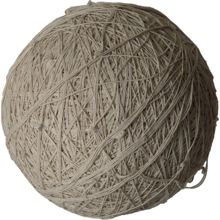 A LARGE 13" VINTAGE BALL OF SLOWLY COLLECTED TIED STRING