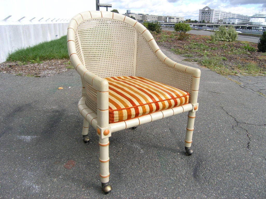 This beautiful armchair by John Widdicomb features a playful cream and orange color scheme. With original striped velvet textile.
