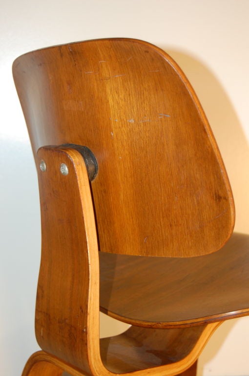 Charles and Ray Eames for Evans Plywood , DCW ( Dining Chair Wood ) in walnut veneer ,designed in 1944 with first production examples appearing in 1945 this chair is an early example with a 1947 postage stamp perforated label to underside .