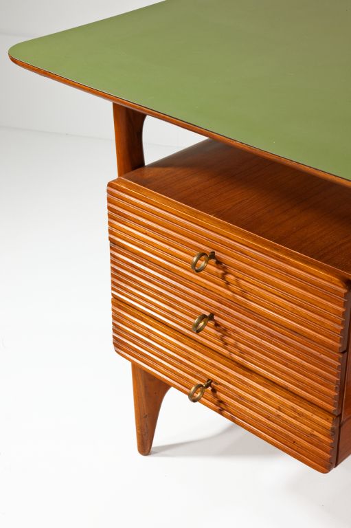 Stylish desk in teak with three drawers and fluted detail to drawer fronts. The top has the original formica. Stamped Cantu in the drawer. Cantu was one of the most important areas for quality furniture making in Italy in this period.