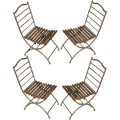 Exceptional Set of 4 Cast Iron Folding Chairs.