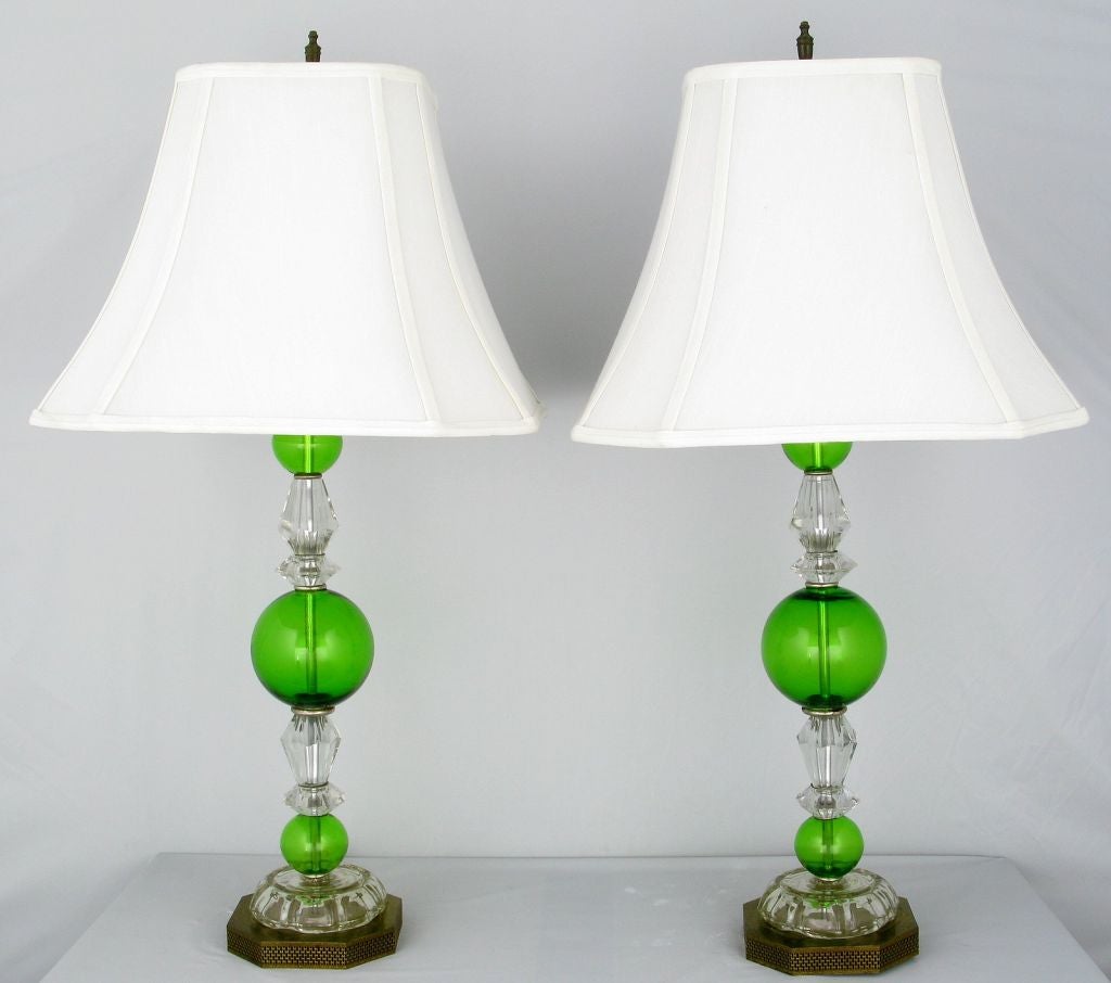 Elegant pair of crystal and green glass sphere table lamps on reticulated octagonal brass base. Sold sans shades.
