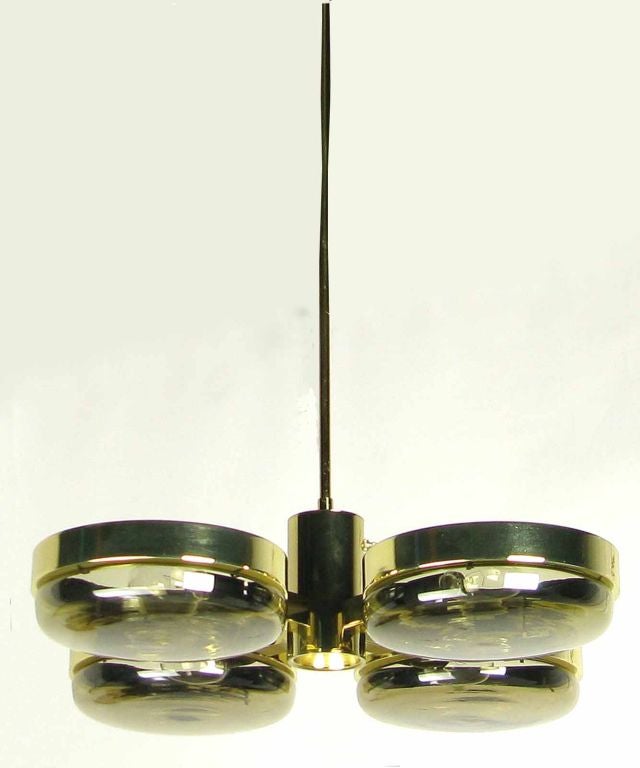 Brass and smoked glass long stemmed orbital four light chandelier,with convex glass inserts in round brass holders. Perfect for a vaulted ceiling or two story foyer, however the stem can be shortened to accommodate a modern dining area or kitchen