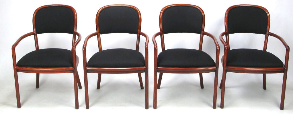 Exceptional set of four chairs by Ward Bennett for Brickel Associates. Bent ash wood frames with oxblood red coloring. New black linen upholstery makes for a striking set.  Would work well around a game table, or in an intimate dining situation.