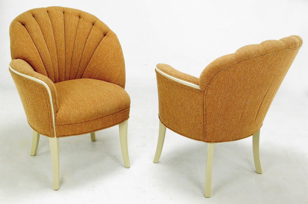 Elegant pair of mirror image art deco shell back fireside chairs in heathered cinnamon-orange upholstery. Solid mahogany frames and legs have been refreshed with new taupe lacquer.