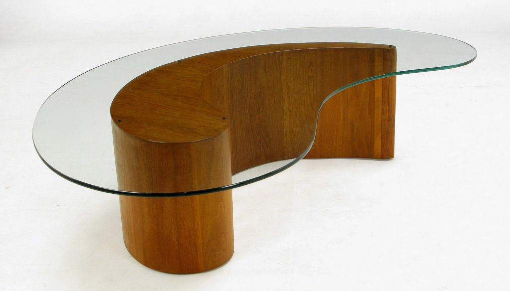 This custom walnut apostrophe or comma shaped coffee table evokes the designs of Vladimir Kagan for Selig. Very well constructed.