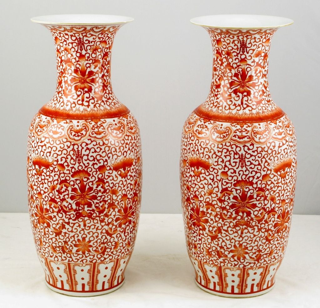 Large and beautifully glazed in persimmon and white floral Asian style pair of trumpeted opening ceramic vases.