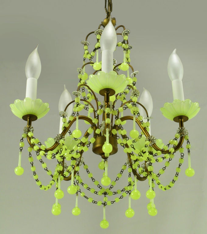 Beautiful and rare chartreuse opalescent glass adorns this five arm brass chandelier from Italy. It also features opalescent glass beads swagged throughout. Perfect for a small elegant dining area or powder room.