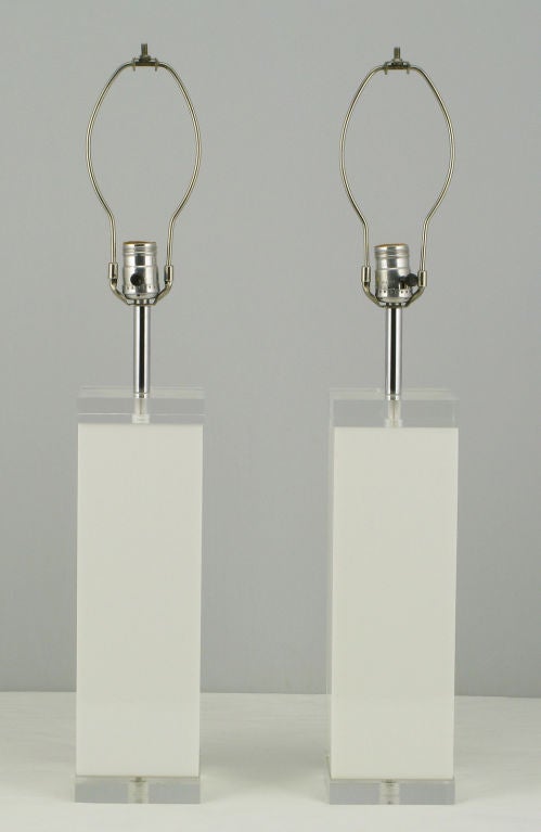 This pair of white and clear Lucite table lamps were custom made back in the 1970s. The clear Lucite top and base has been polished out and appear as new. The white Lucite bodies are in the same wonderful condition. Chromed steel stems, sold sans