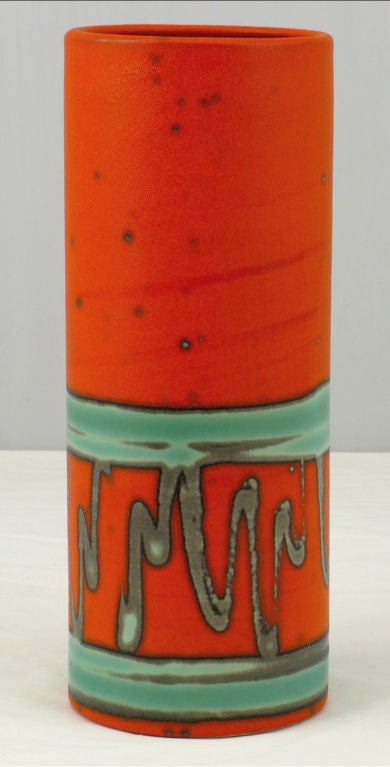 Abstract tube shaped pottery vase by Haeger Potteries of East Dundee Illinois. Excellent color in tangerine orange glaze on the inside, as well as out. Accented by a turquoise blue and gray-green abstract design.