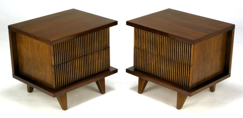 Striking and unusual, this pair of American of Martinsville walnut cased night stands feature unusual reeded pecky cypress drawer fronts. The overall shape and design is very Nakashima influenced.