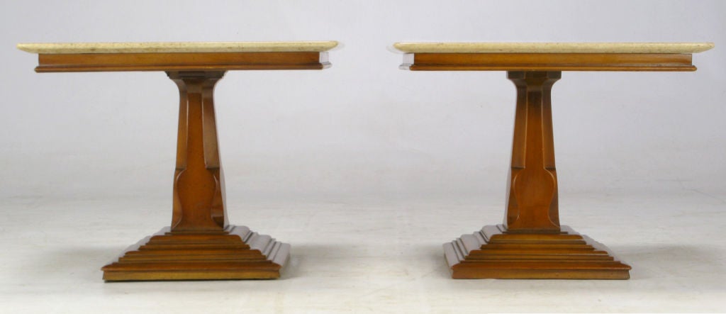 These excellent Neo-Gothic style carved pedestal end tables  feature a multi-stepped plinth base with a slab of Portugese knife edge travertine. Very good build quality, on par with vintage Baker or Henredon. Could also be used as bunching tables,