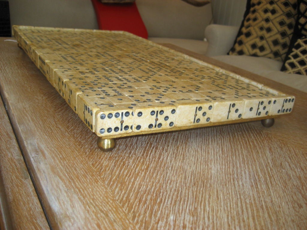 Great looking tray covered in dominoes with a footed base