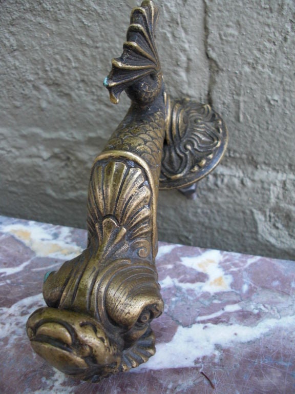 It's not the only bronze dolphin doorknocker you'll see but the cast is extra nice and I haven't seen one with the original knocker 