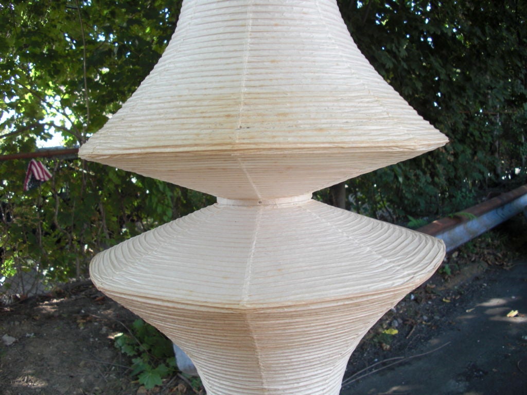 A very large ( 8 feet and 7 inches tall) vintage paper hanging lamp by Noguchi, stamped with the early mark ( see detail photo). A fantastic sculptural statement