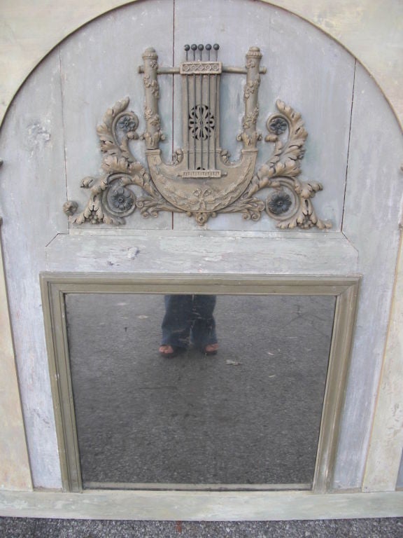 A beautifully designed and large French Directoire ( 1790's-1810) painted  trumeau mirror with applied terracotta lyre and acanthus leaf decoration. We have to stress what a nice neo-classical architechtural design it has. We had this item