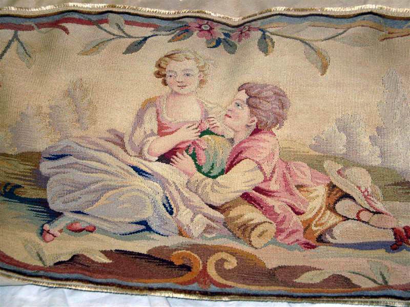 19th C. Aubusson Figural Tapestry of a romantic couple inset on light cream colored washed linen.  There are colors of pink, blue, green, lavender, grey, brown, cream, and taupe that can be found in the tapestry textile. A fine silk gimp seperates