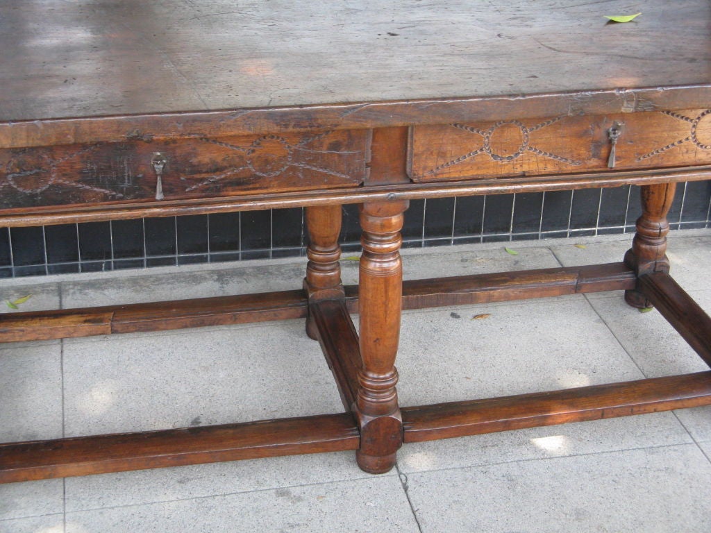 Rustic Walnut two drawer tavern table from the last part of the 1700's.  Top has wonderful old beautiful patina.  This piece would be a great addition to any Mediterranean style home.