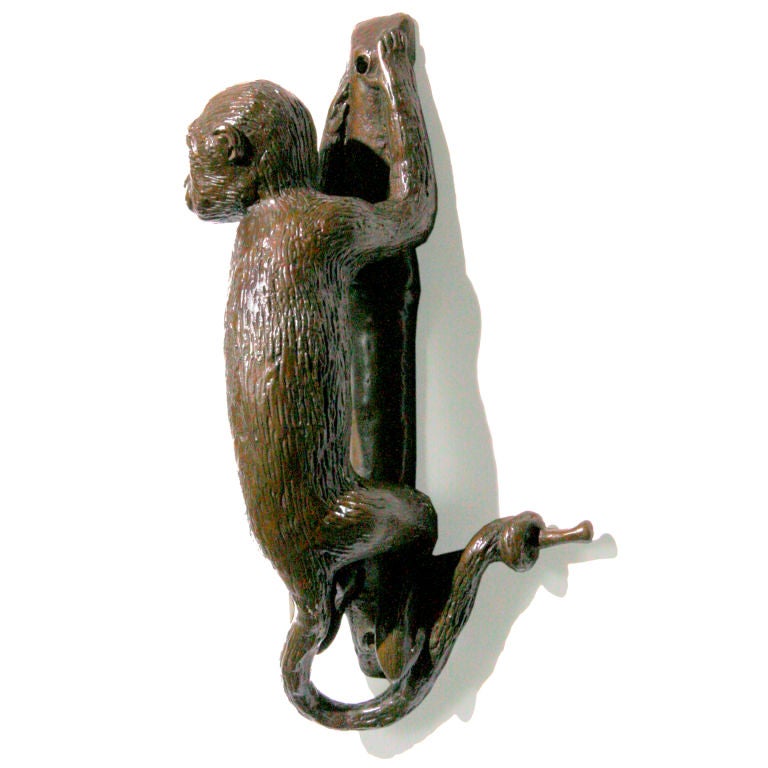Pair of limited edition French bronze door handles.  The cast bronze figures are small monkeys with their tails wrapped around a branch.  A right and a left facing handle.  Several pairs available.