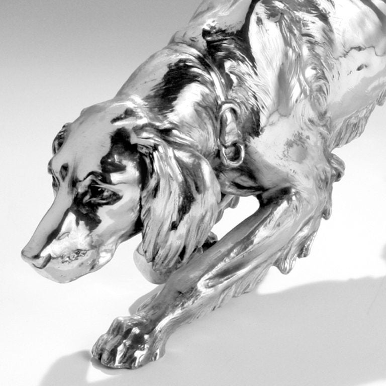 Extraordinary large silver plate over spelter hunting dog. This rare in size decorative dog, over two feet in length, has excellent detail and resembles a Brittany spaniel, Irish setter or other sporting dog. He is in a natural crouching position,