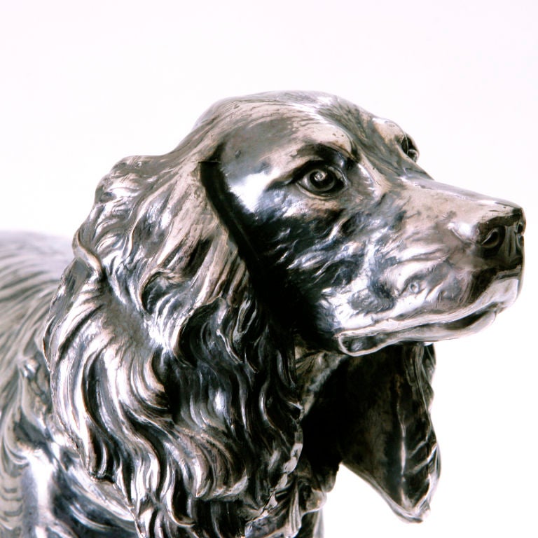 Realistically detailed cocker spaniel dog.  Created by the original Jennings Bros Company of Bridgeport, Connecticut (started in 1891), a metalwork company famous for their realistic animal figures.  Their figures were done in spelter:  a white