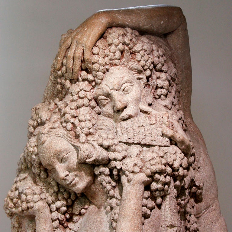 Captivating sculpture of the half-goat God, Pan, playing the Syrinx (Panpipes) while seducing a Nymph, probably Psyche! Sculpted from a single large piece of rough granite.