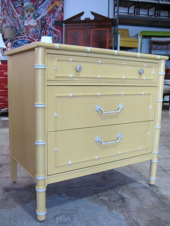 Elegant pair of faux bamboo end tables/cabinets/chests. Lovely yellow finish with lighter highlights on the faux bamboo.<br />
For additional credenzas, sideboards, bureaus, cabinets, chests, end/side/center/console/coffee/card/game/night/dining