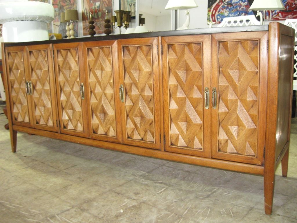 Elegant Mid century sideboard, with intricate geometrical front door panels. This cabinet had a very beautiful top, slate style top with intricate pattern, see pics. <br />
For additional, consoles, credenzaas, sideboards, bureaus, desks, dressers,