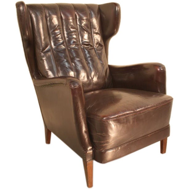 An original 1950’s leather Danish wing armchair For Sale